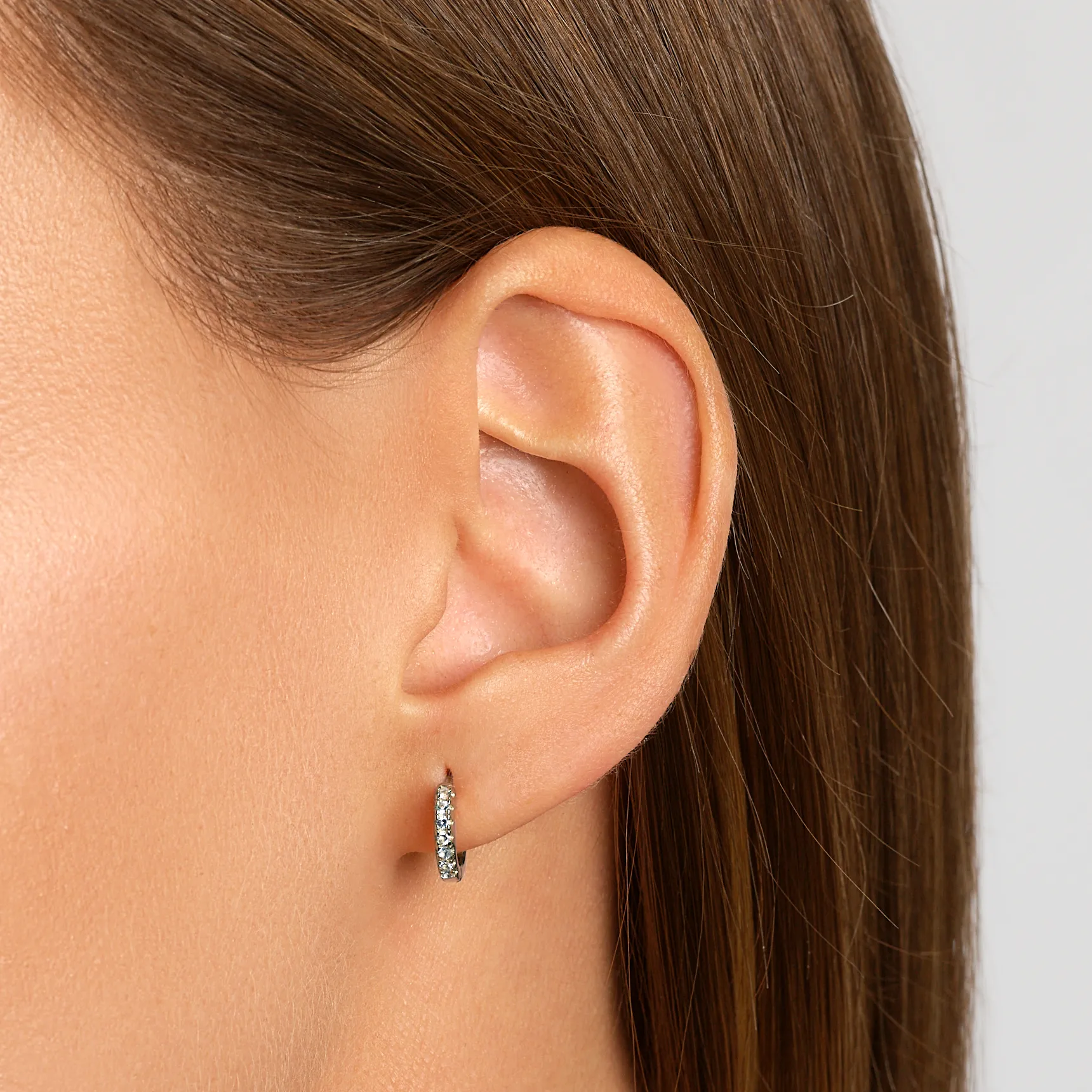 White Topaz Rainbow Huggie Earrings in Silver